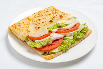 Fresh lettuce, ripe tomatoes, and tender chicken wrapped in a soft crepe await enjoyment