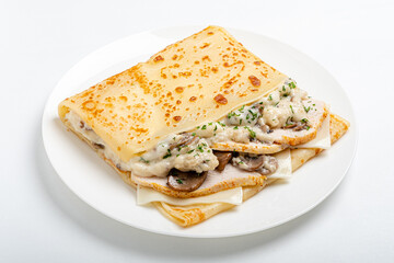 Tasty crepes filled with chicken and mushrooms in a creamy sauce, beautifully garnished