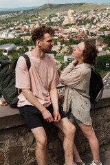 A couple explores the historic Abanotubani district in old town of Tbilisi on taxi and by foot...