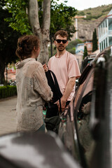 A couple explores the historic Abanotubani district in old town of Tbilisi on taxi and by foot...