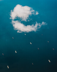 Aerial clouds over the ocean filled with boats