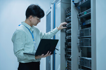 Computer engineer is setting up network in server room,Systems Maintenance Technician,Male engineer...