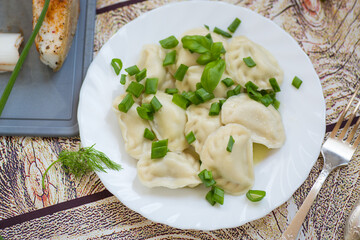 Homemade dumplings with potato filling and fresh herbs