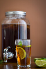 Refreshing kombucha in a glass jar and a glass with lime