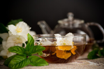 Cup with jasmine tea on a black background