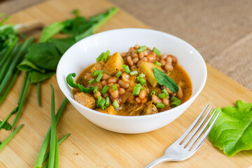 Traditional stewed stew with beans and meat in a country kitchen