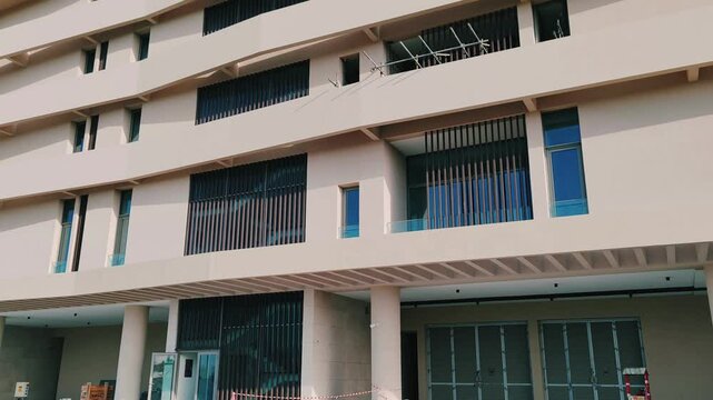 Modern design Aluminum shape Multi Baffle Cladding Decoration. Balcony Facade Architecture Panel with Black Horizontal Metal, Wood stripes. Exterior view multistory building with black glass windows.