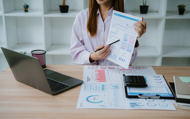 Happy cheerful asian young woman holding paperwork, reading tax refund paper bill, receive good news, enjoying with offer from check post mail on bank receipt payment message letter feel excited.