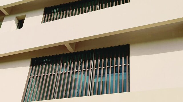 Modern design Aluminum shape Multi Baffle Cladding Decoration. Balcony Facade Architecture Panel with Black Horizontal Metal, Wood stripes. Exterior view multistory building with black glass windows.