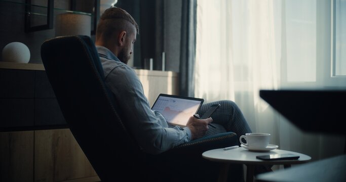 Stock Exchange Broker Using Tablet Computer and Smartphone, Analyzing Real-Time Stocks and Exchange Market Charts in Online Trading App. Successful Investment Agent Working in Financial Agency Office