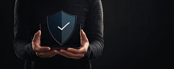 Person holds tablet displaying security shield icon