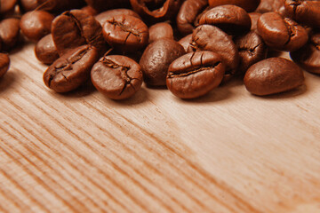 Coffee beans on wooden texture background. Drink, cheerfulness, pleasure concept.Close up. Copy space.