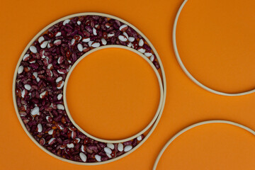 Colorful beans and round frames. Orange background