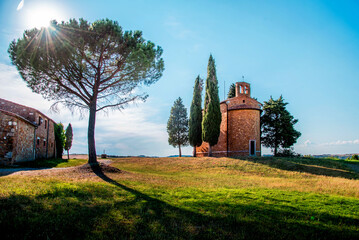Magic landscape with chapel of Madonna di Vitaleta on a sunny day in San Quirico d'Orcia (Val d'Orcia) in Tuscany, Italy. Excellent tourist places.