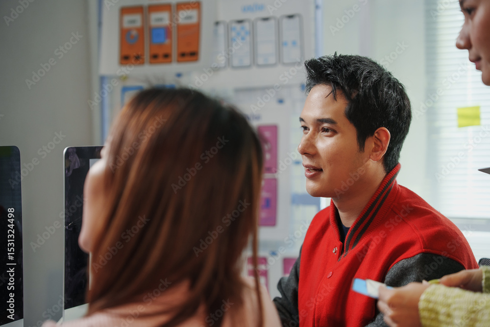 Aufkleber asian uiux designers collaborating in an office, developing a mobile app while engaged in teamwork a