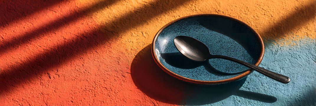 World eating disorders day concept with shadow of a spoon on plate. Mental disorder, anorexia, bulimia. Mental health problem. World Hunger Day. Copy space. Horizontal banner