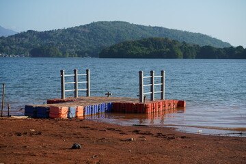 Floating Dock on a Lake Shore with Hills in Background