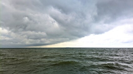 Dark clouds over the sea before a thunderstorm in the afternoon. Severe weather, thunderstorms, extreme weather