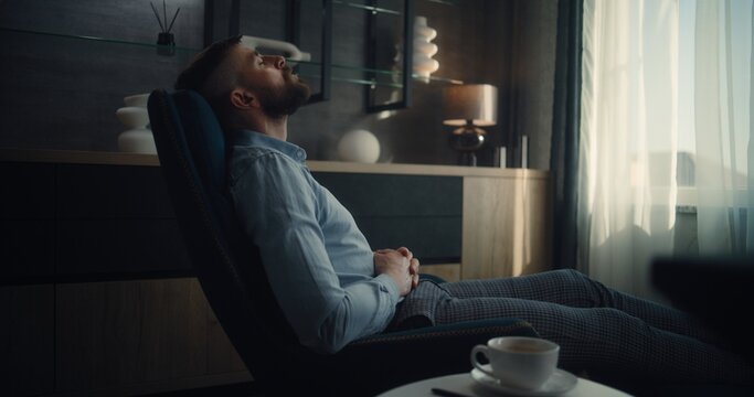 Professional Financial Expert Sitting in Chair with Closed Eyes, Resting After Work and Hard Trading Day. Successful Businessman in Comfortable Home Office or Investment Bank Office. Dolly Shot.