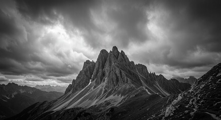 Grayscale Mountain Peak Under a Cloudy Sky