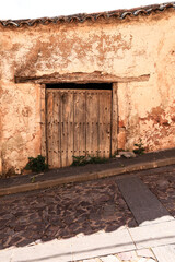 Old wooden door of derelict house in Spain