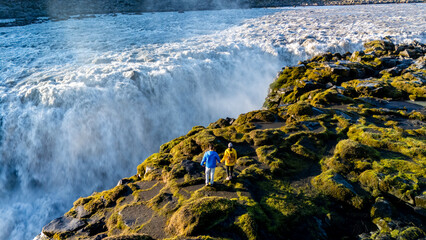 Witness breathtaking Dettifoss waterfall in Iceland, where travelers stand in awe of the powerful...
