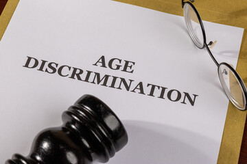 A civil rights legal file labeled "Age Discrimination" lies open next to a gavel, illustrating the legal framework protecting older adults from bias.