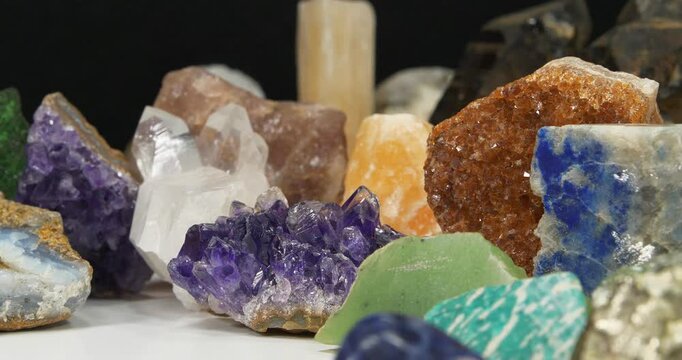 Natural Semi Precious crystals and minerals, riches of Earth. Purple Amethysts, Gypsum, Quartz crystals, green Nephrite, Lazurite, yellow Calcite and Citrine, Amazon stone, Green garnet and other