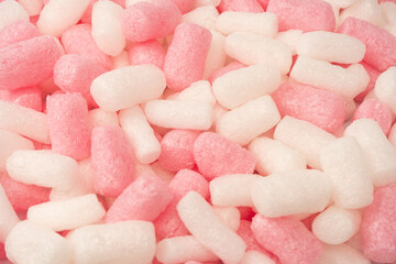 Pink and white box filler as a background. Top view.