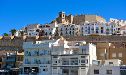 view of Peñíscola, a coastal city in Spain, located in the region of Valencia. The city is known for its castle, built on a rocky peninsula that juts out into the sea