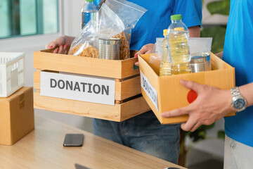 Donation Process. Volunteers carrying donation boxes filled with essential supplies.