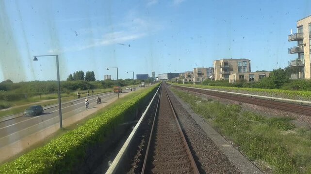 Copenhagen, Denmark An elevated Metro train on the M1 line passes the modern buildings in the Orestad district.