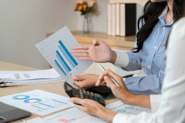 Data Presentation and Financial Insights. Professionals discussing financial graphs and reports.