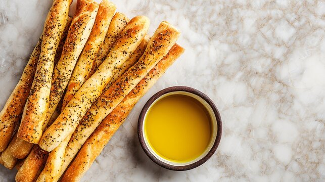 Italian breadsticks with dipping olive oil, top down view, rustic marble surface and minimal design