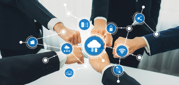 A group of business professionals collaborates using cloud technology, symbolizing teamwork and innovation in digital solutions within a modern corporate environment. Amity