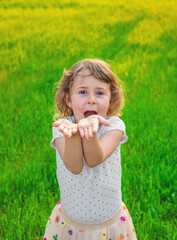 Child blowing a kiss. Selective focus.