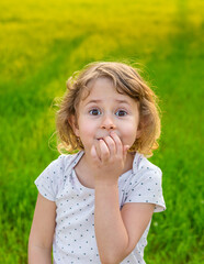 Child picking his nose. Selective focus.