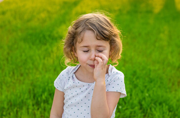 Child picking his nose. Selective focus.