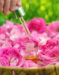 Rose essential oil in a bottle. Selective focus.