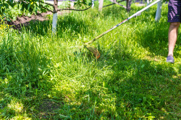 mow the grass in the garden. Selective focus.