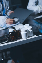 Male and female doctors are having a meeting in a hospital room.
