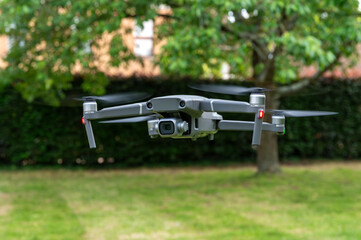 Drone with camera, Drone flies against the background of trees and sky, unmanned flying object,...