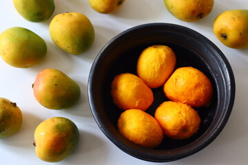 Peeled ripe mangoes in an earthen pot, ready for cooking in a Kerala style curry with yogurt, coconut, and spice