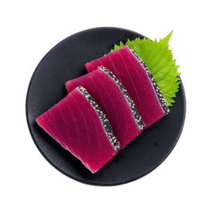 Fresh slices of raw tuna sashimi on black plate with green shiso leaf, showcasing vibrant colors and textures. Perfect for Japanese cuisine presentation