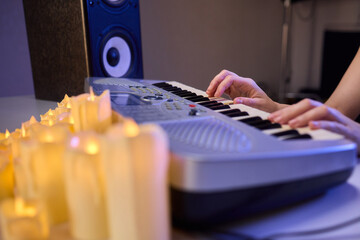 Hands play a keyboard in a modern studio, showcasing creativity and passion for music