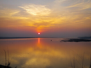 A amazing scenery of sunset in the horizontal line of a river