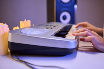 Hands play a keyboard in a modern studio, showcasing creativity and passion for music
