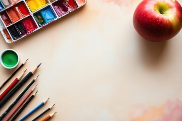 Art supplies and apple on a light beige background