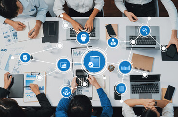 Top view analyst team utilizing BI Fintech to analyze financial data at table in meeting room. Analytic BI dashboard power on paper for business insight and strategic marketing planning. Prudent Amity