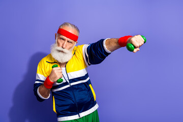 Elderly man in retro sportswear exercising with hand weights against a vibrant background,...